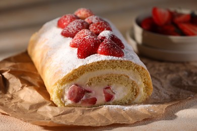 Photo of Delicious cake roll with strawberries and cream on table, closeup