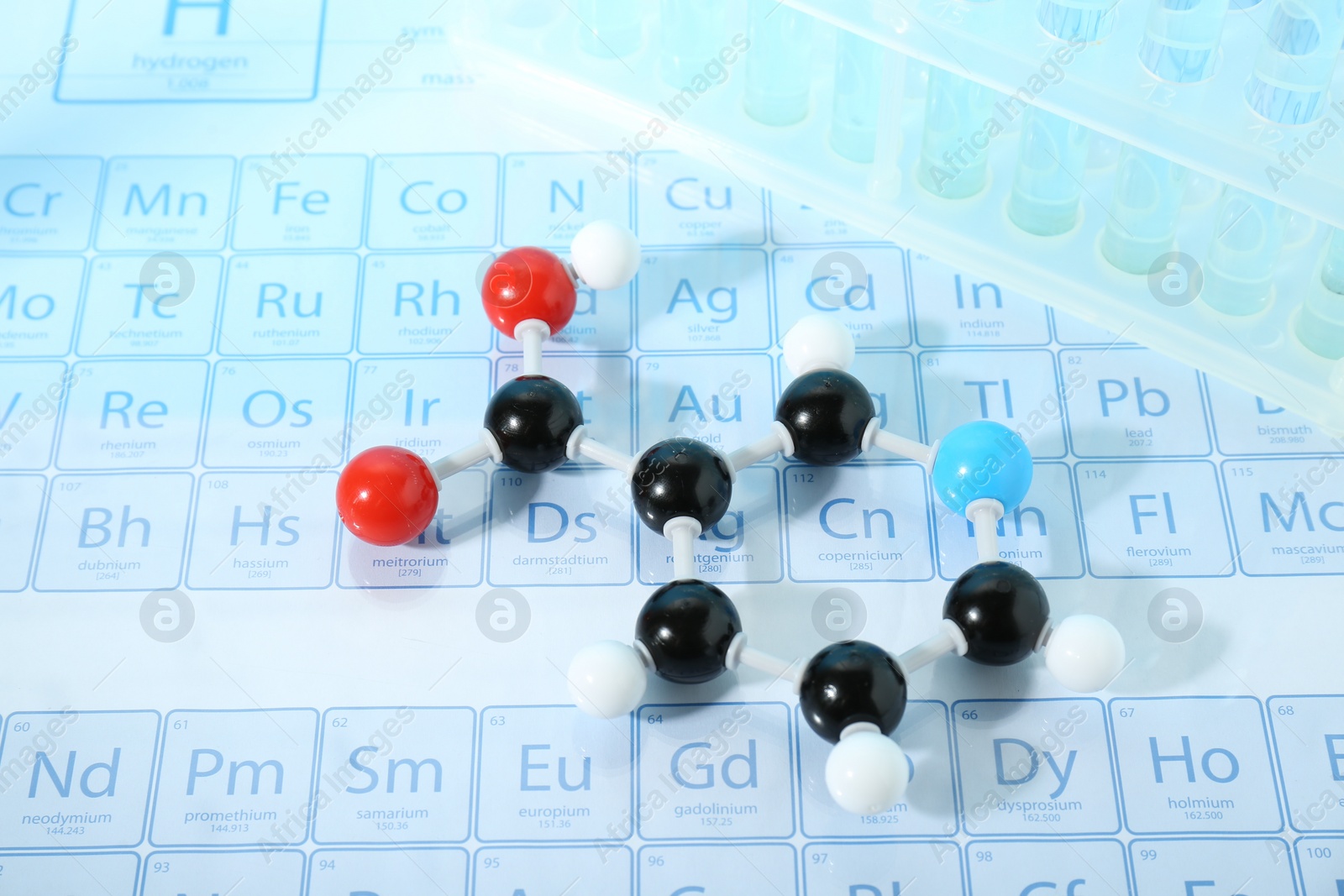 Photo of Molecular model and test tubes on periodic table