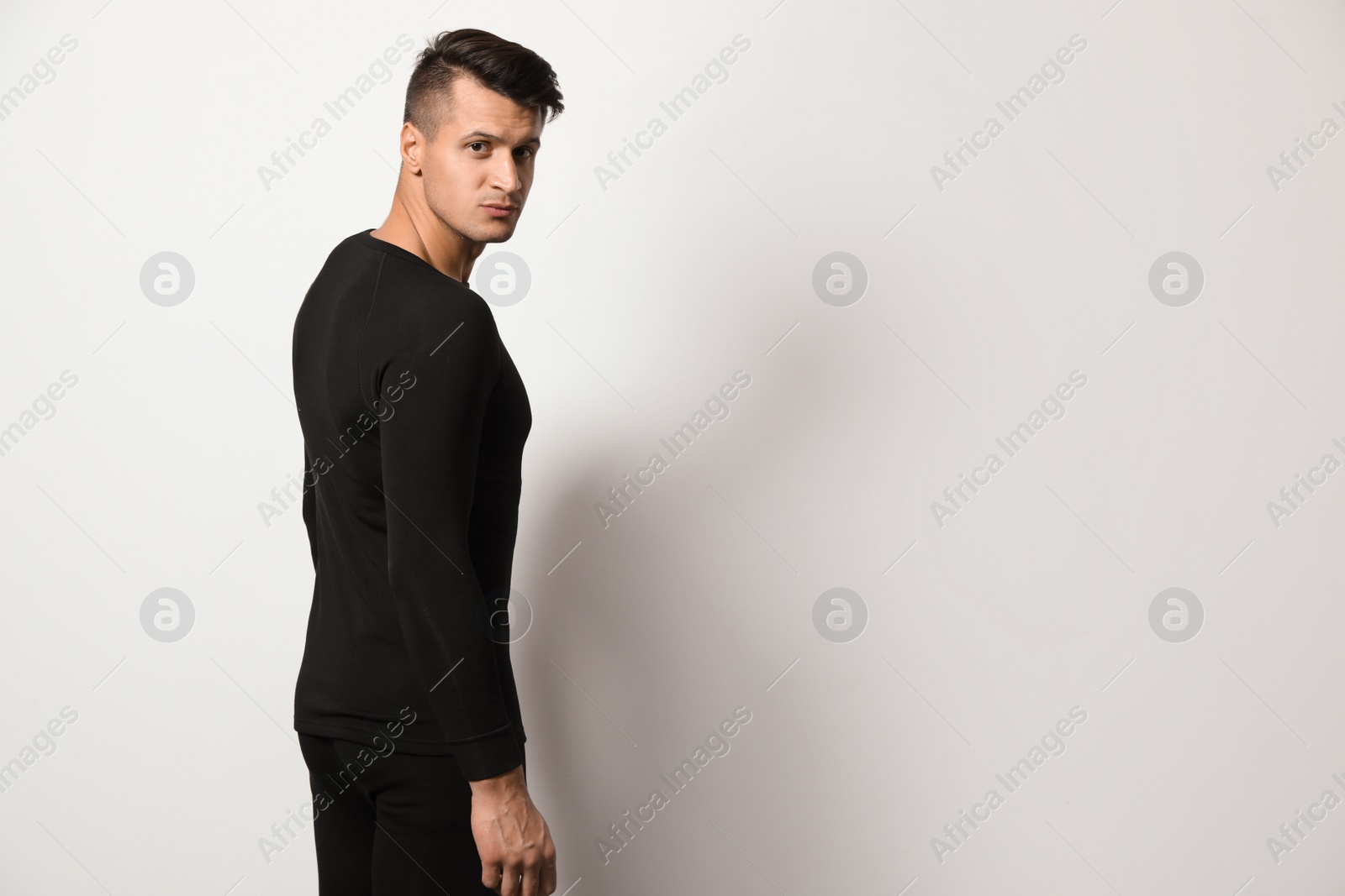 Photo of Man wearing thermal underwear on light grey background. Space for text