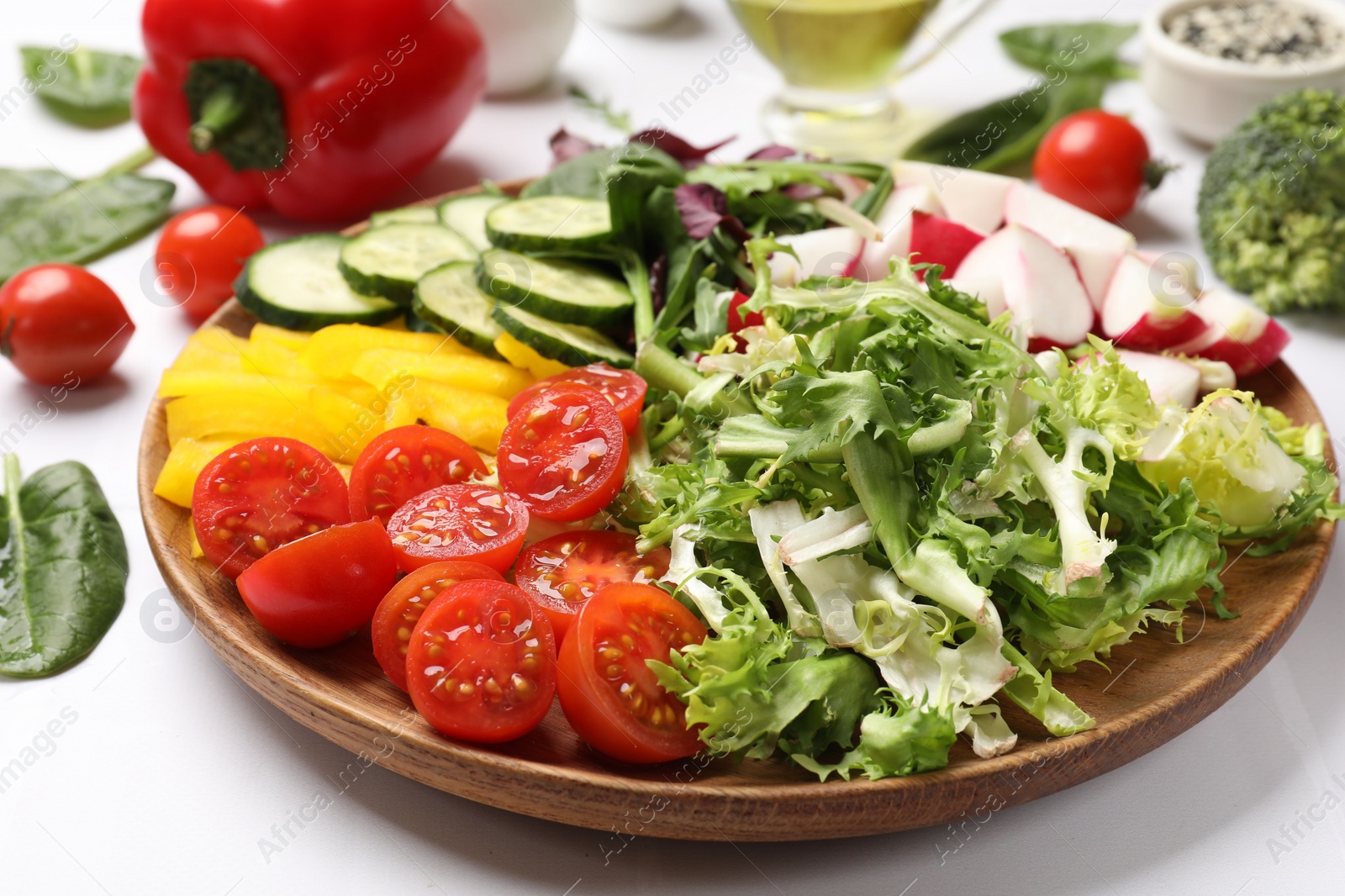 Photo of Vegetarian diet. Plate with tasty vegetables at white table, closeup