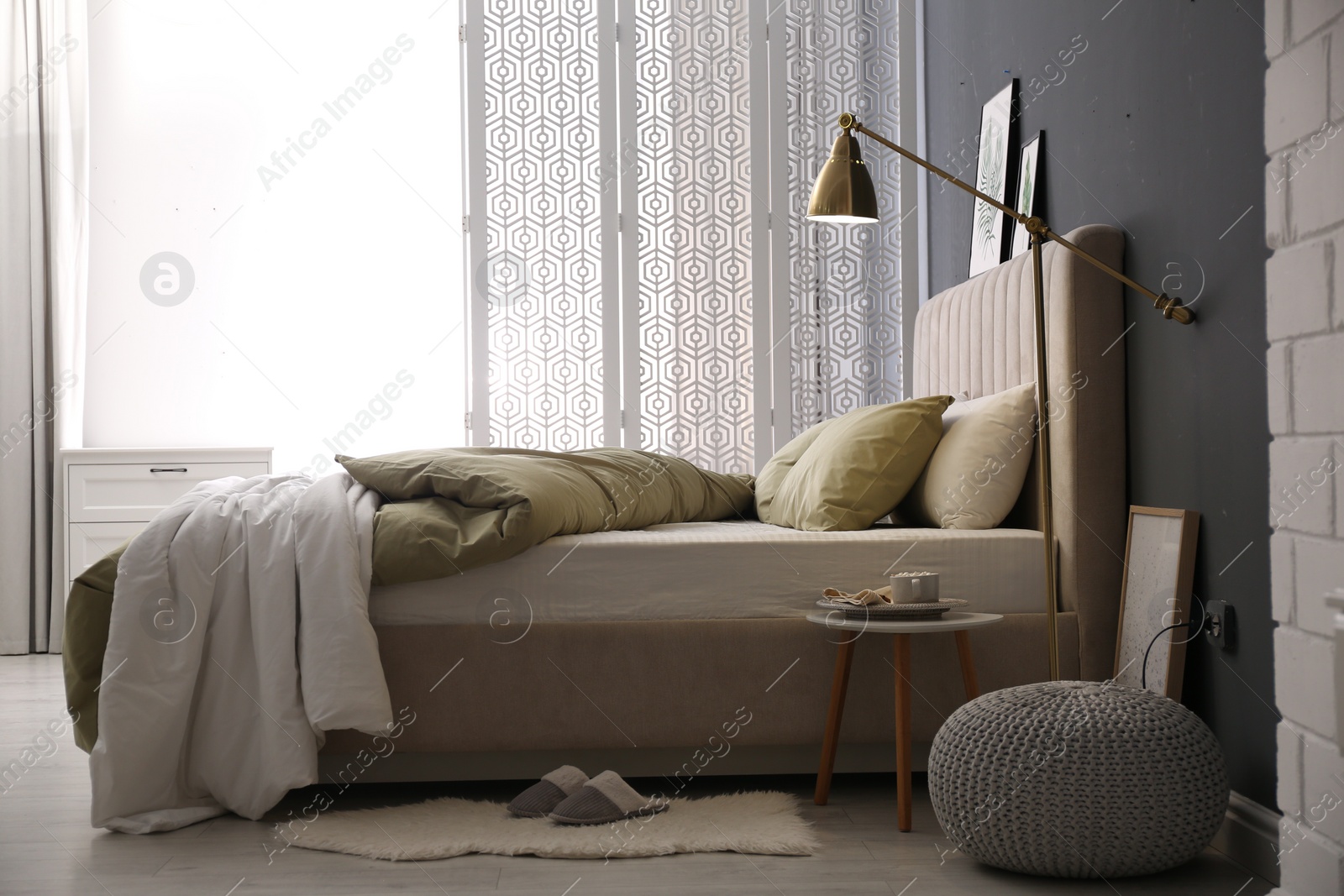 Photo of Comfortable bed with new pistachio linens in modern room interior