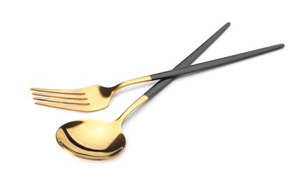 Photo of Shiny golden fork and spoon isolated on white. Luxury cutlery