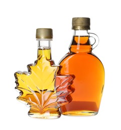 Photo of Different bottles of tasty maple syrup on white background