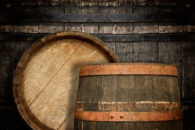 Image of Two wooden barrels near old textured wall