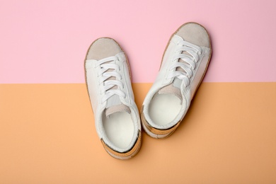 Stylish new shoes on color background, top view