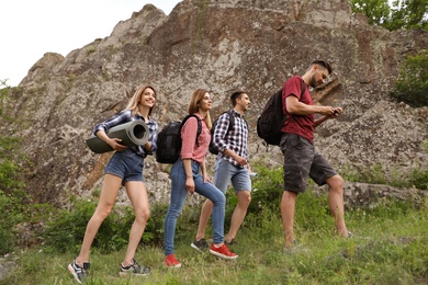 Group of young people hiking in wilderness. Camping season