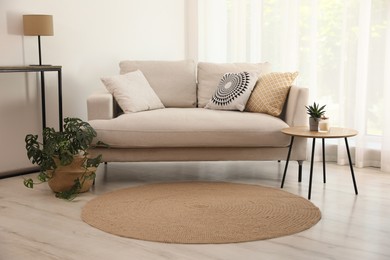Photo of Living room interior with comfortable sofa and stylish round rug