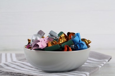 Photo of Candies in colorful wrappers on white table