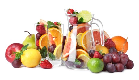Photo of Jug and glasses with different fruits on white background