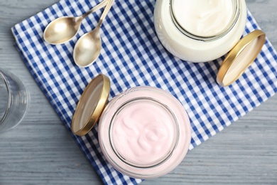 Photo of Jars with tasty yogurt on table, top view