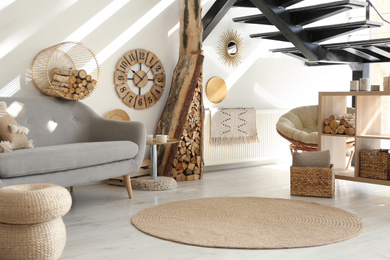 Stylish room interior with firewood as decorative element