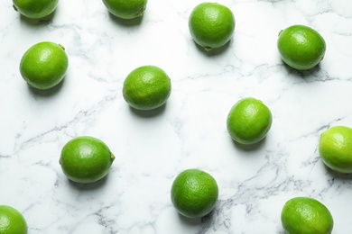 Fresh ripe green limes on marble background