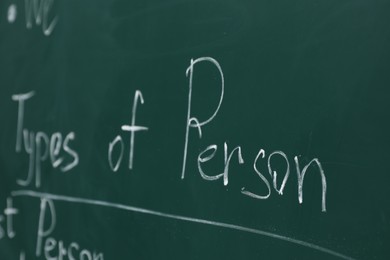 Photo of English grammar rules written with chalk on green board, closeup