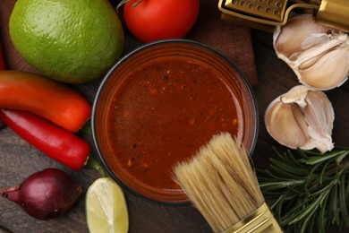 Photo of Tasty marinade and products on wooden table, flat lay