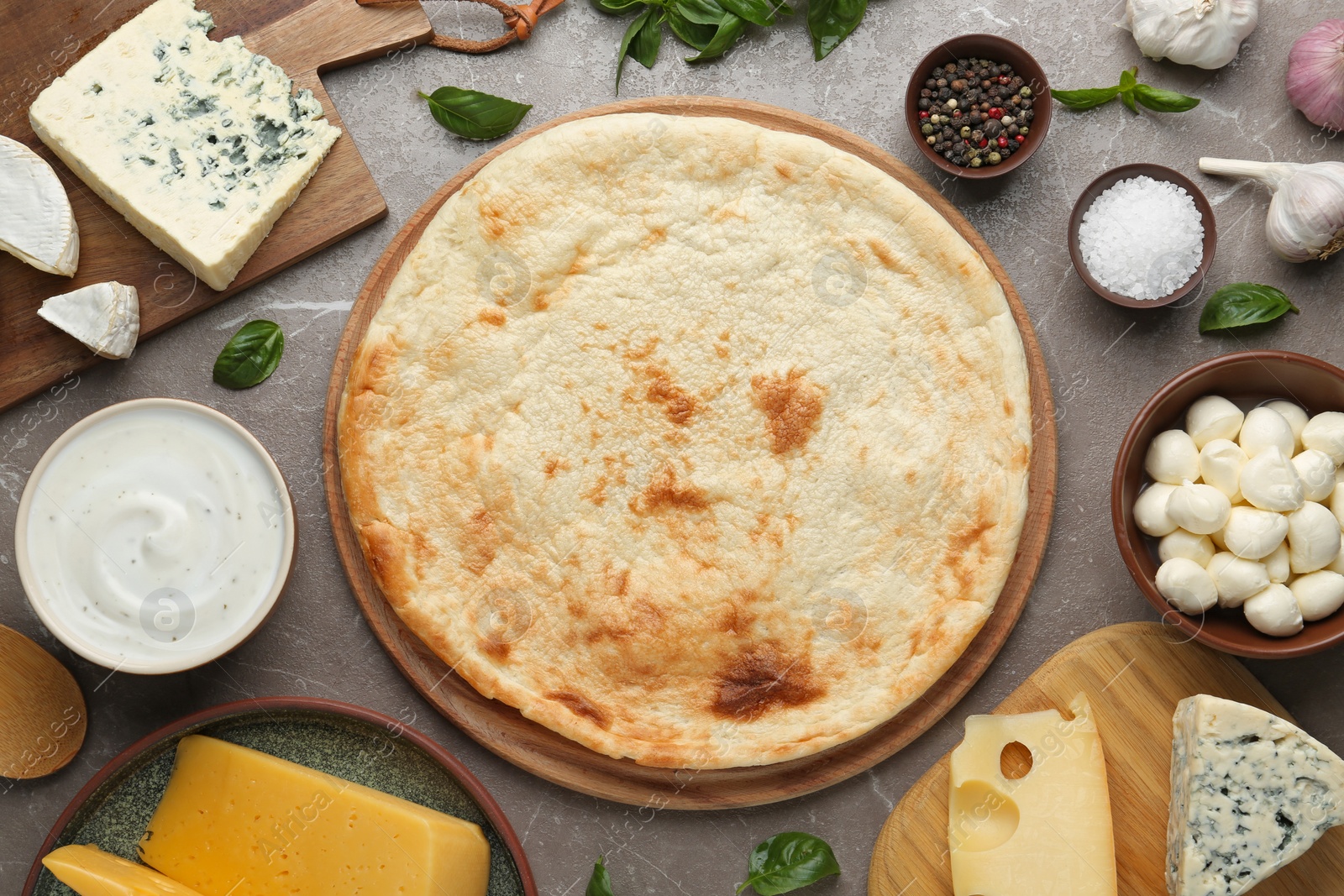 Photo of Flat lay composition with pizza crust and fresh ingredients on table