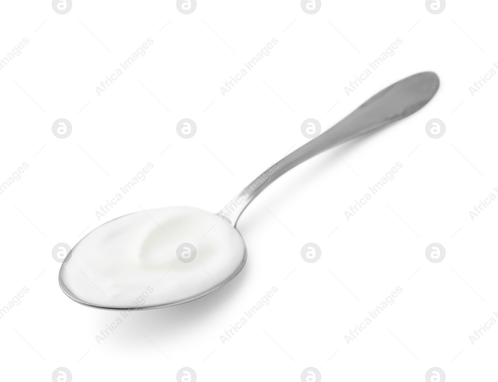 Photo of Delicious natural yogurt in spoon isolated on white