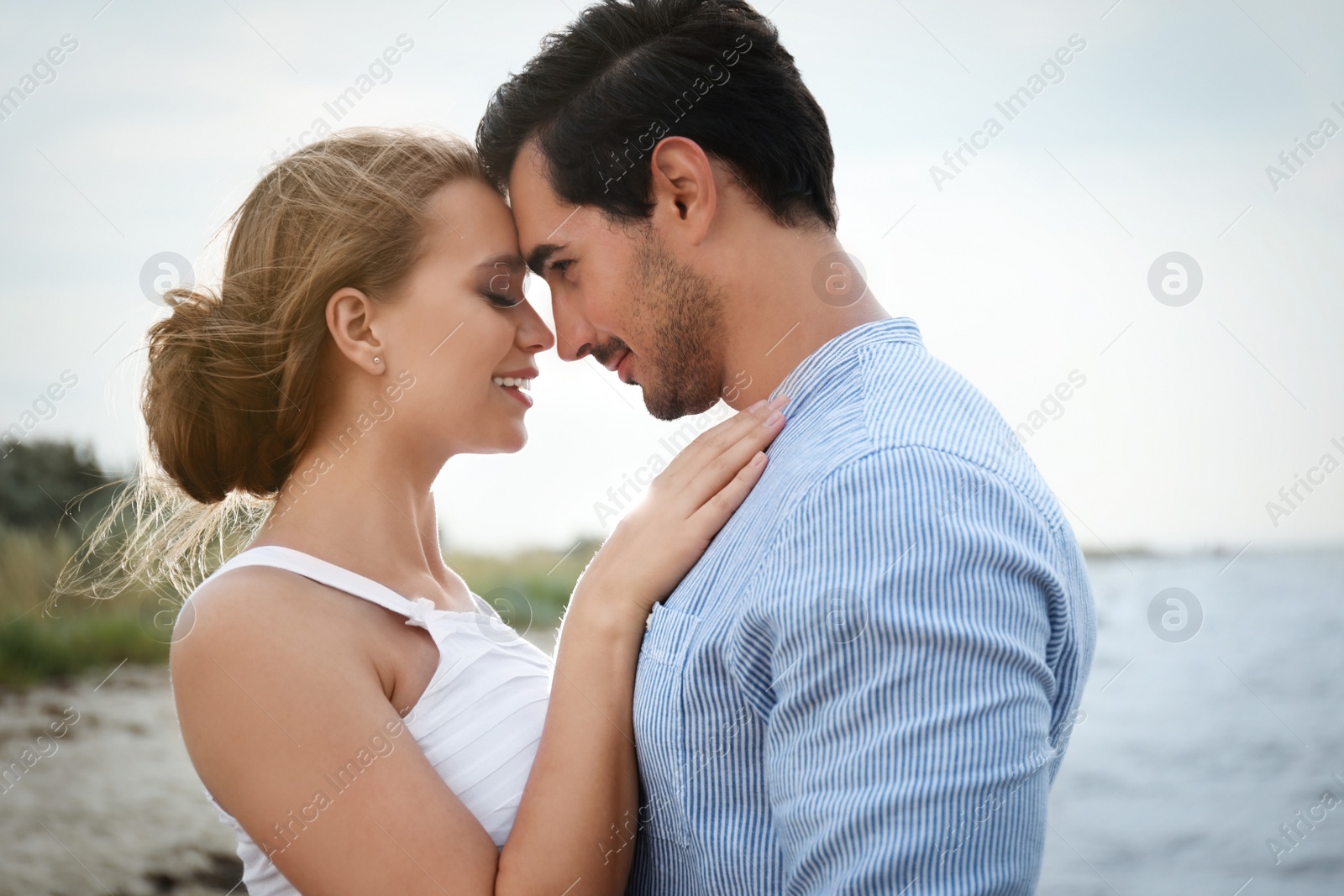 Photo of Happy young couple spending time at sea beach