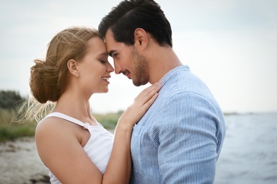 Happy young couple spending time at sea beach