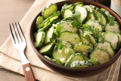 Delicious cucumber salad on wooden table, closeup