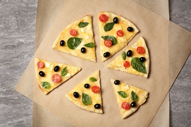 Flat lay composition with slices of tasty homemade pizza on table