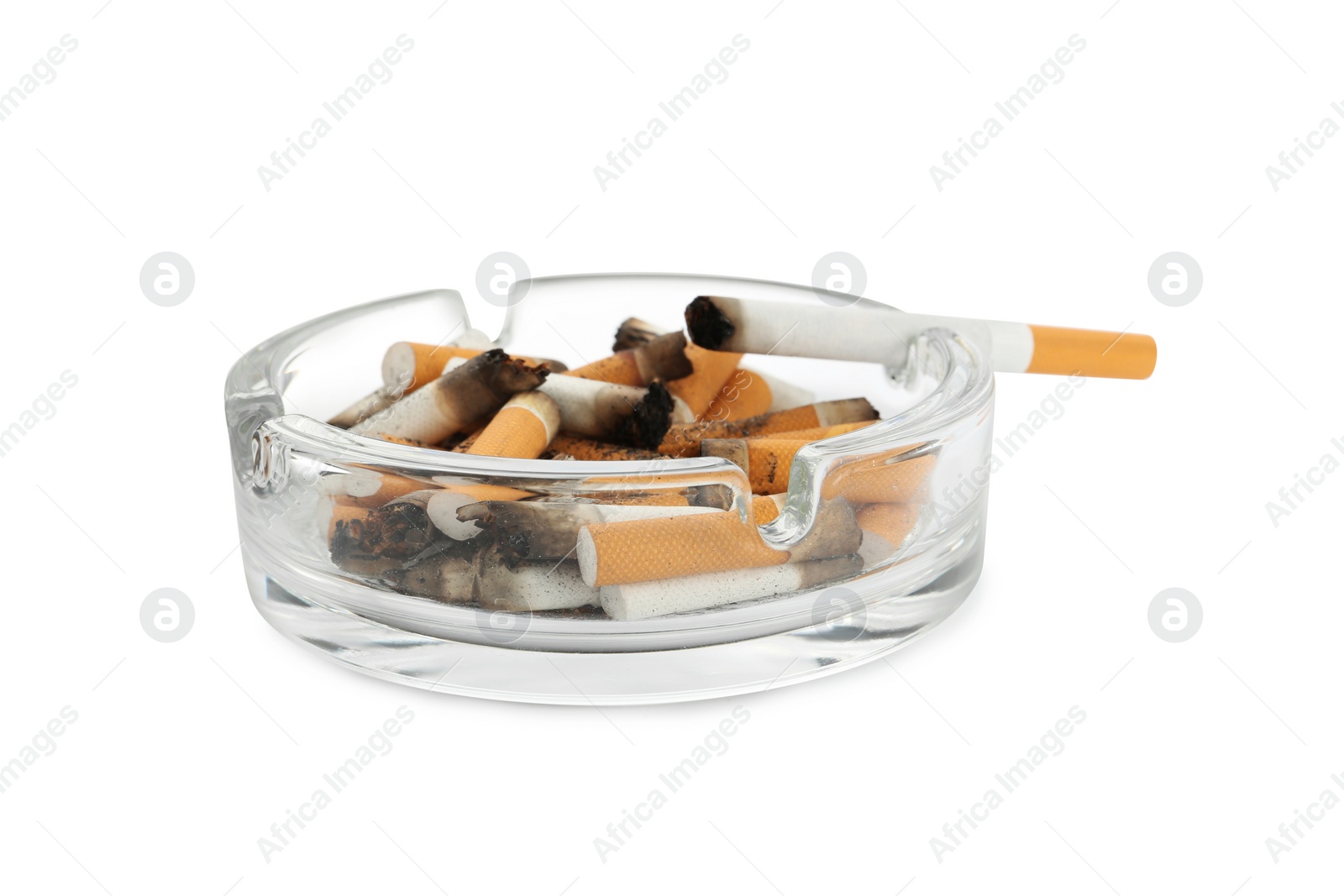 Photo of Glass ashtray with cigarette stubs isolated on white