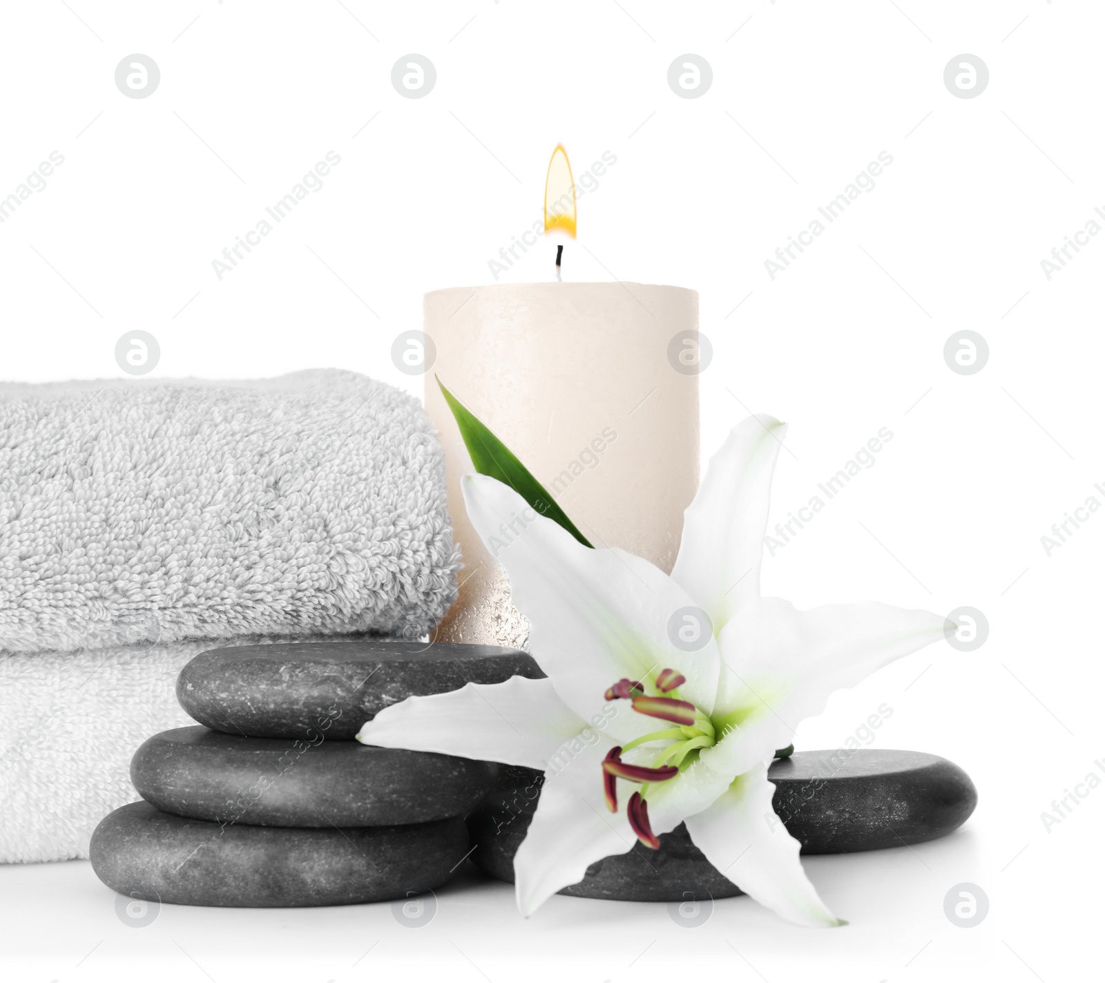 Photo of Composition with spa stones, towels and flower isolated on white