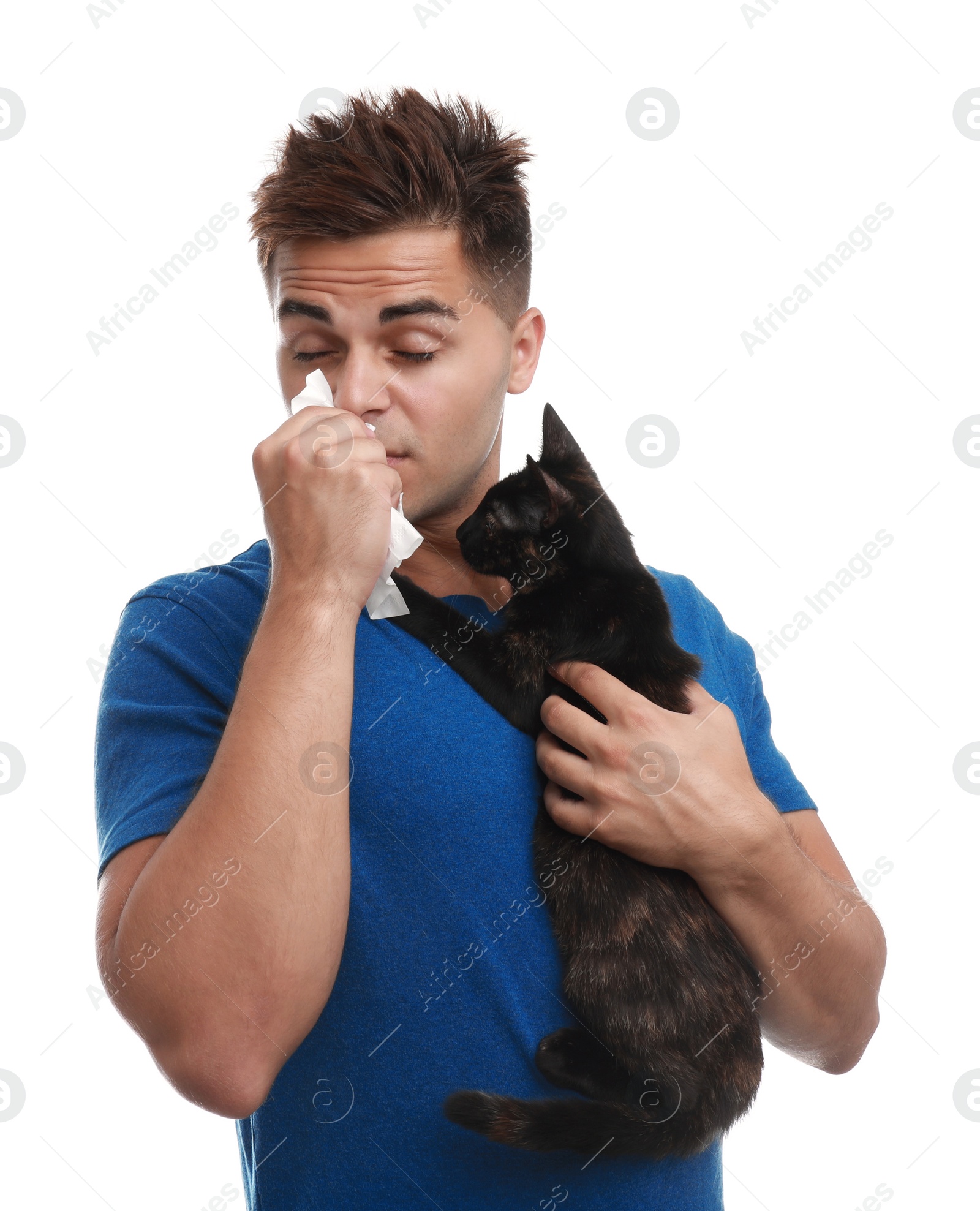 Photo of Young man with cat suffering from allergy on white background