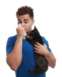 Photo of Young man with cat suffering from allergy on white background