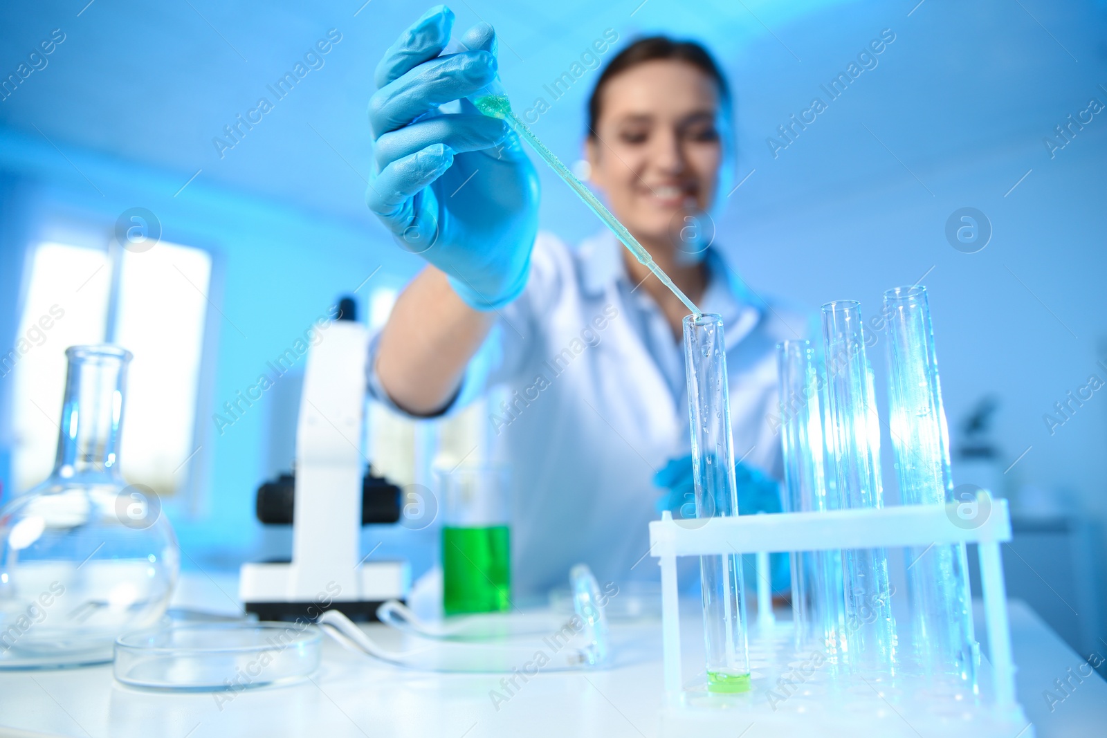 Photo of Female scientist working with sample in modern chemistry laboratory