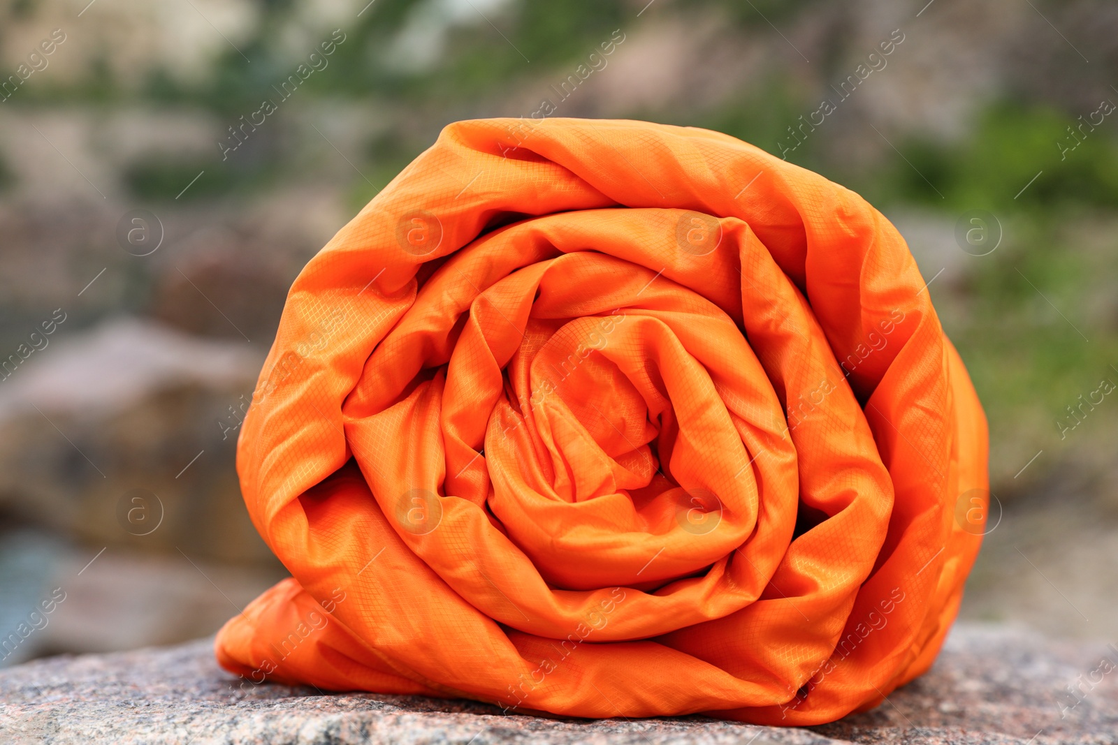 Photo of Rolled sleeping bag outdoors on sunny day, closeup