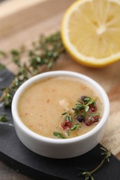 Photo of Delicious turkey gravy, thyme and peppercorns on board, closeup