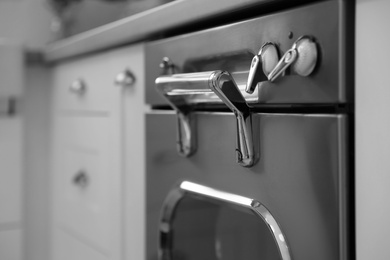 Photo of New modern oven in kitchen, closeup view