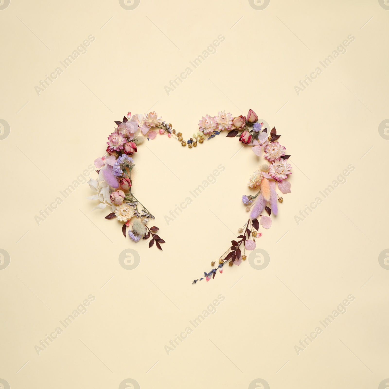 Photo of Beautiful heart shaped floral composition on beige background, flat lay