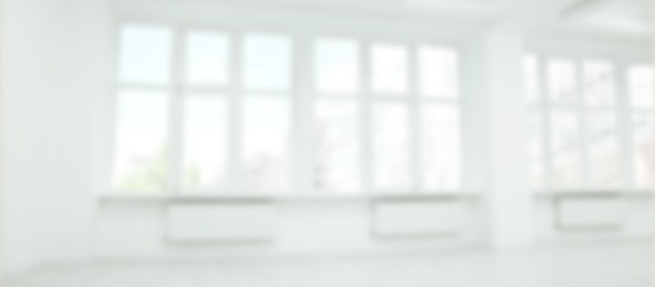 Image of Empty room with white wall and large windows, blurred view. Banner design