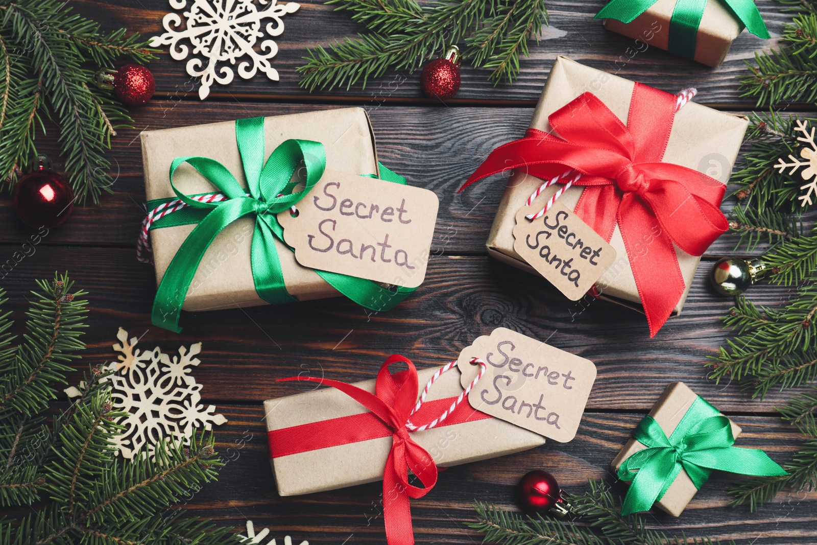 Photo of Flat lay composition with presents from secret Santa on wooden background