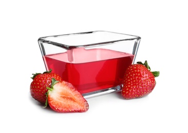 Strawberries and tasty jelly dessert in glass bowl on white background