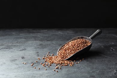 Buckwheat grains on grey table. Space for text