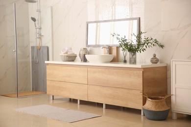 Modern bathroom interior with stylish mirror and vessel sink