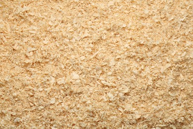 Photo of Dry natural sawdust as background, top view