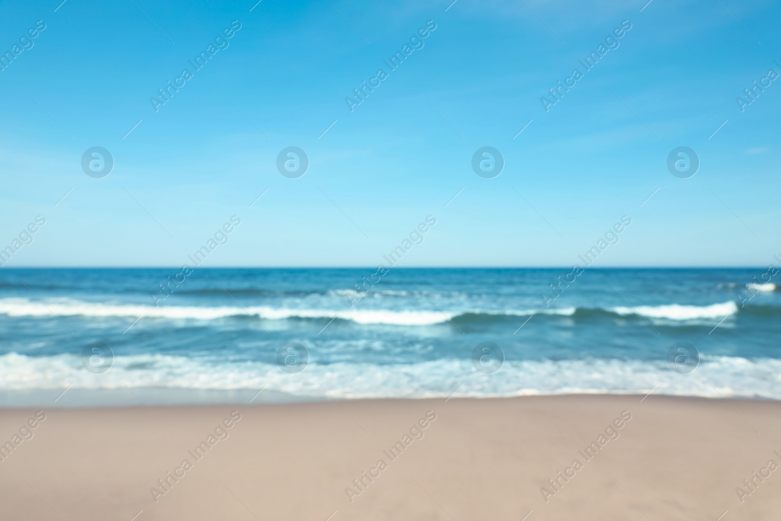 Photo of Blurred view of beautiful sea and sandy beach on sunny day