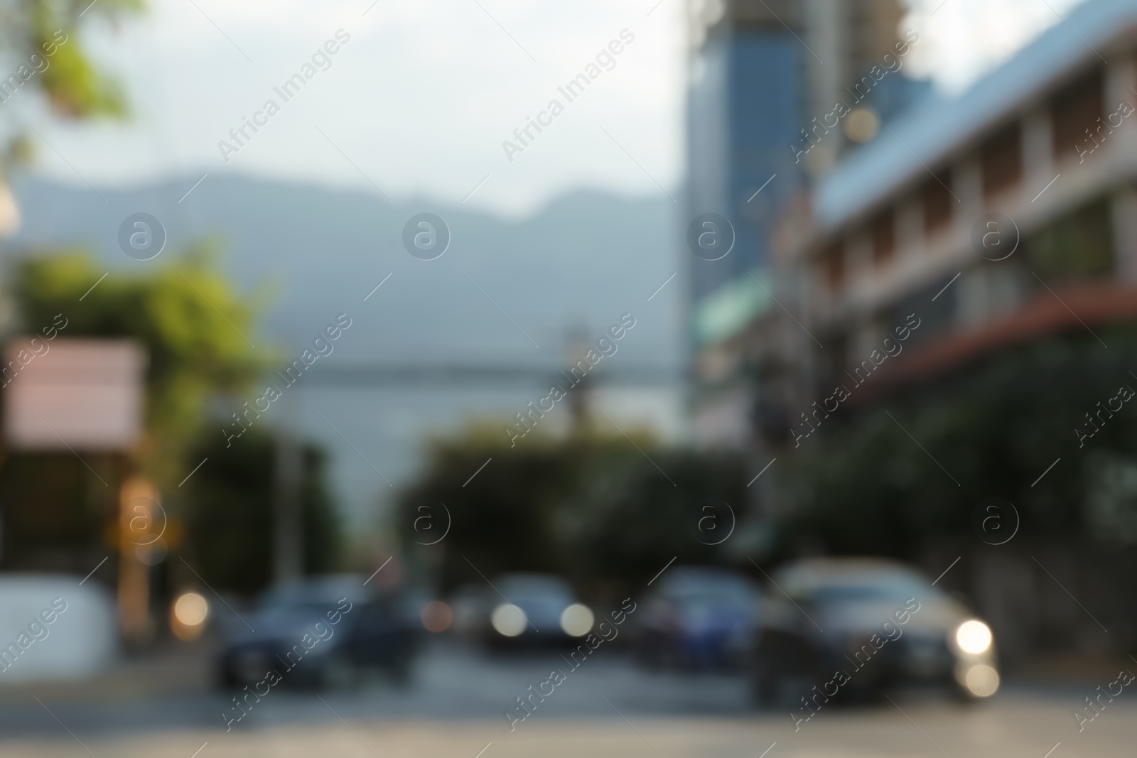 Photo of Blurred view of cityscape with cars on road. Bokeh effect