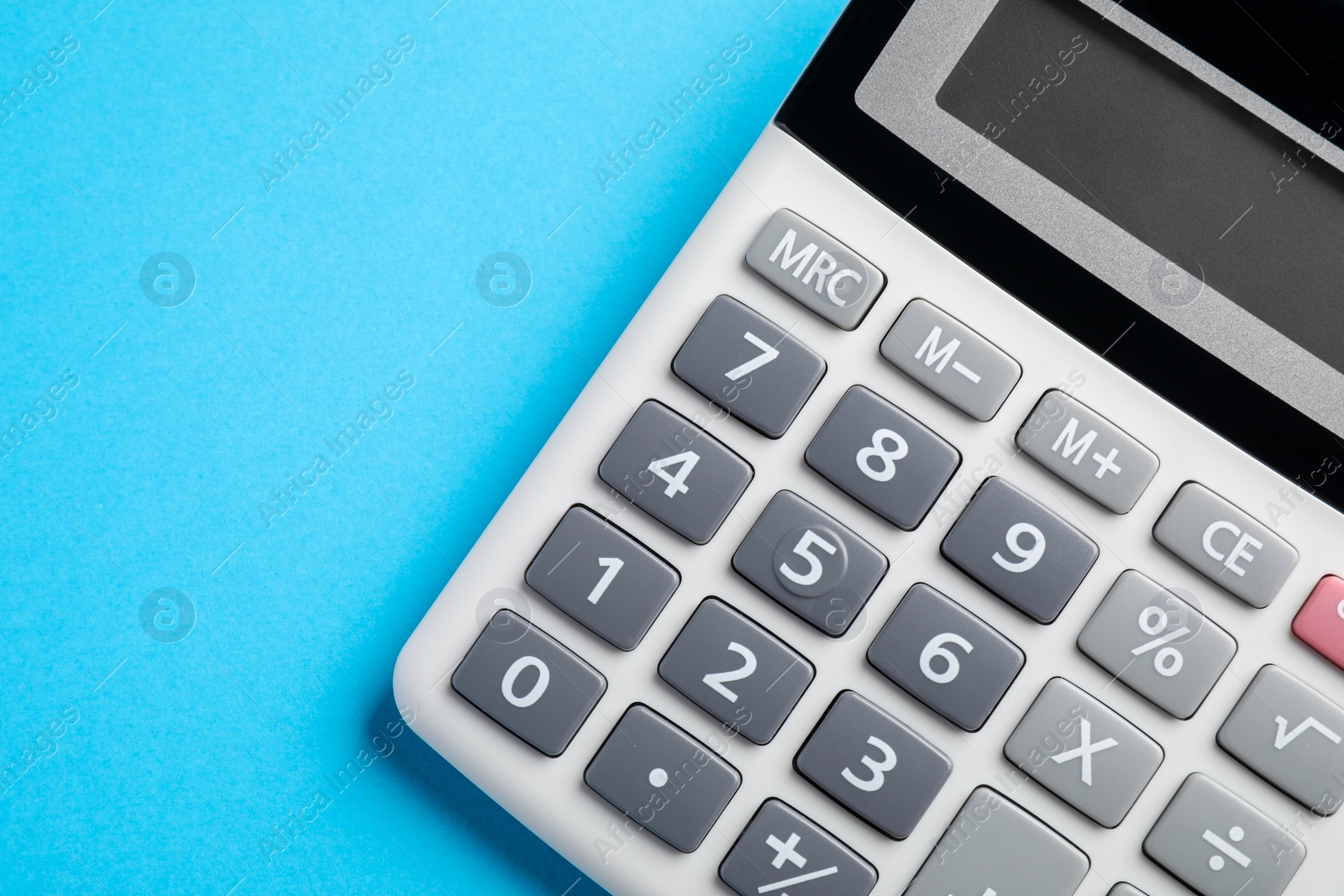 Photo of Calculator on light blue background, top view. Space for text