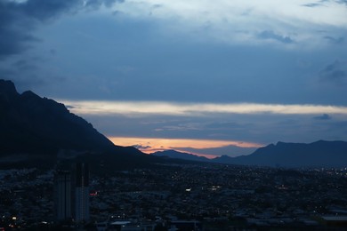 Picturesque view of sunset over city and mountains