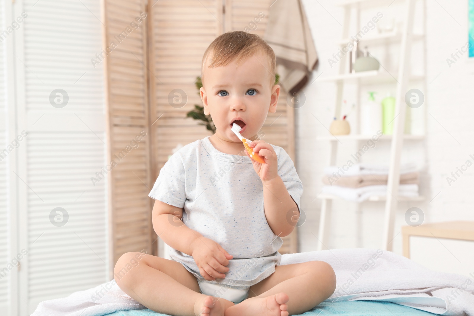 Photo of Cute little boy with toothbrush on blurred background