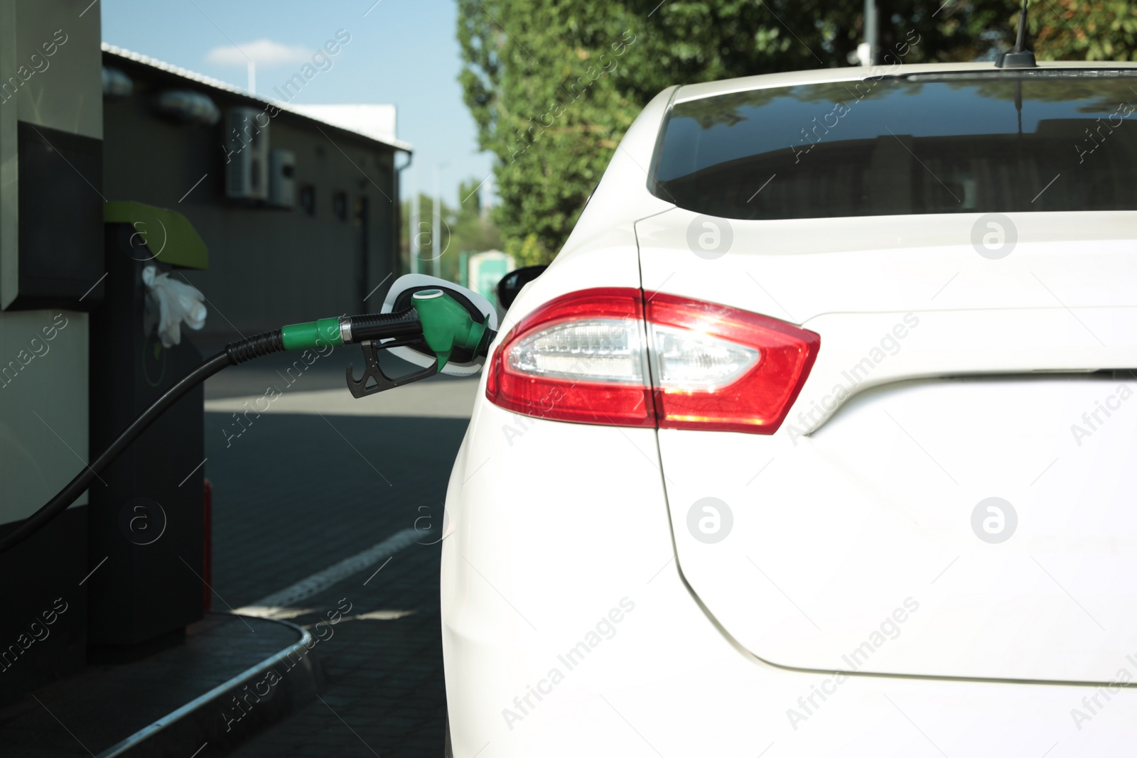 Photo of Refueling modern car with petrol pump on gas station, closeup