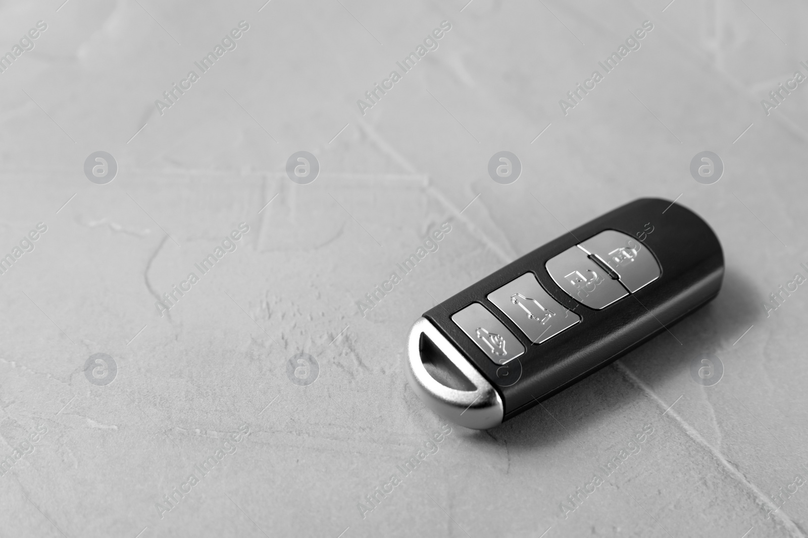 Photo of Remote car key on grey background. Space for text