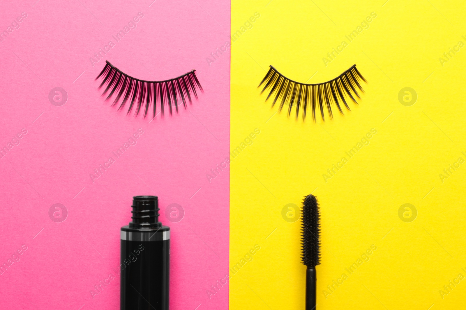Photo of False eyelashes and mascara on color background, flat lay