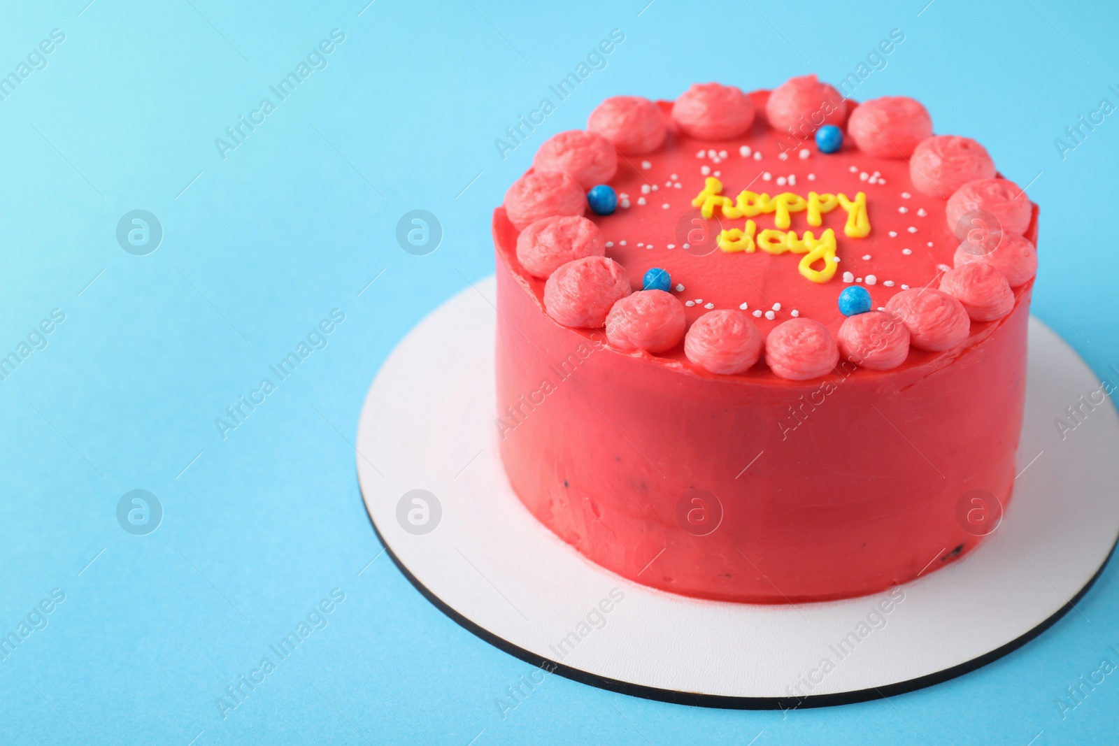 Photo of Cute bento cake with tasty cream on light blue background, space for text