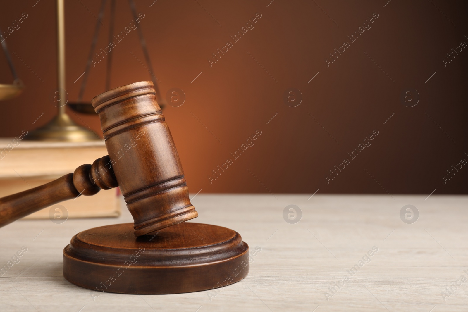 Photo of Wooden gavel on white table, space for text. Law concept