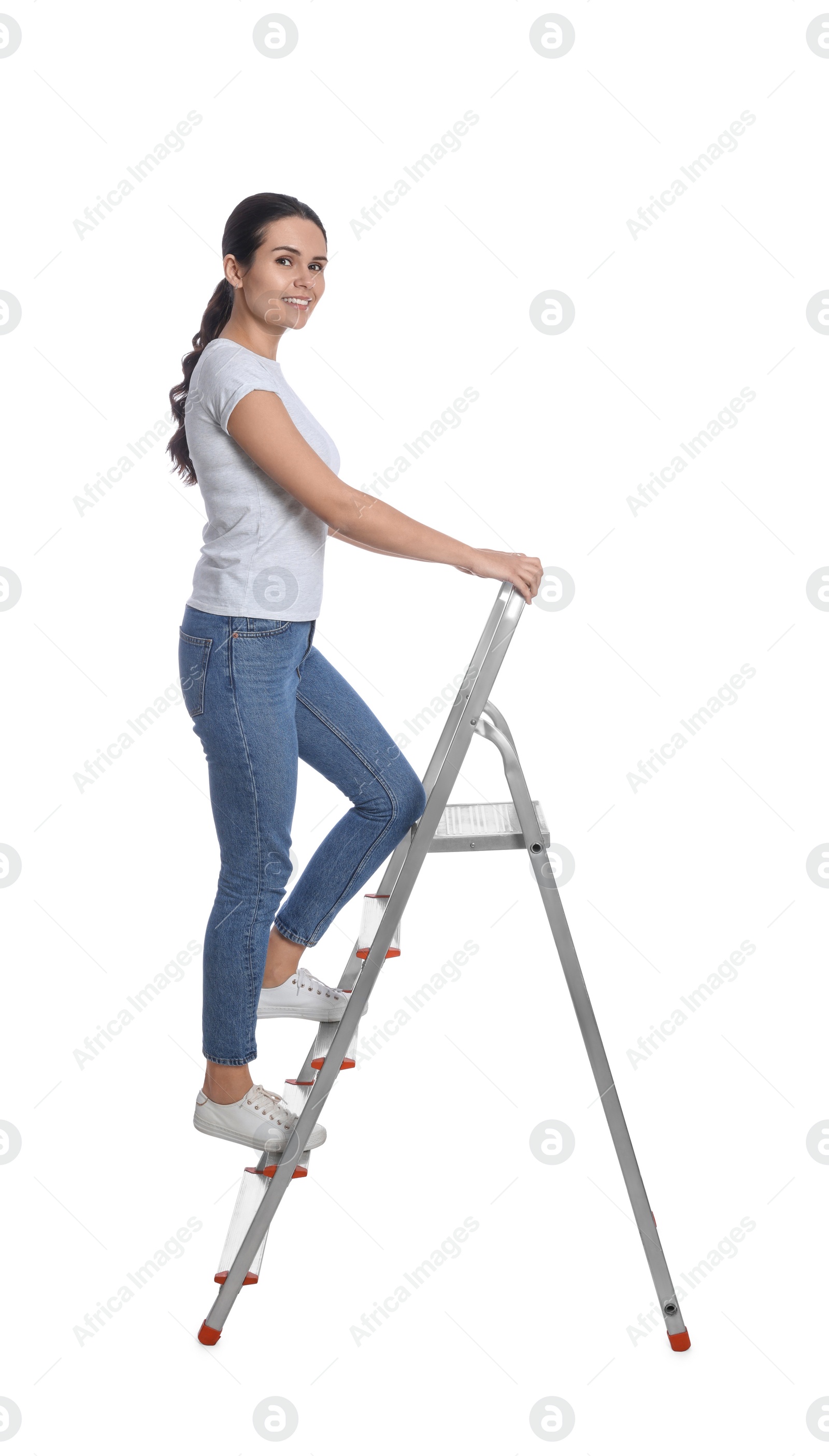 Photo of Young woman climbing up metal ladder on white background